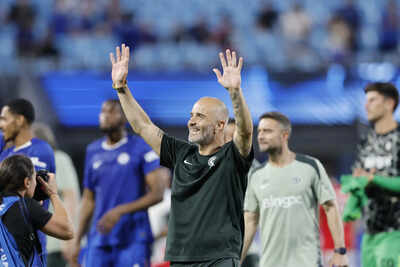 Chelsea's coach waves to fans after a delayed match.